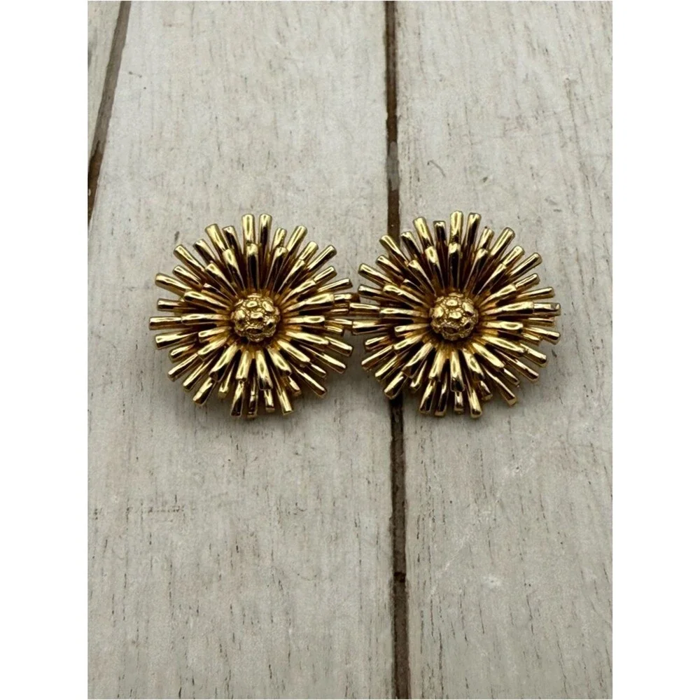 Vintage Monet gold tone starburst flower clip on earrings